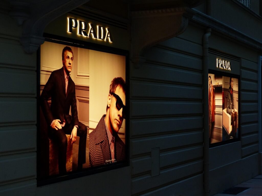 advertising, advertising board, advertising sign, advertising poster, prada, overhead projector, neon sign, brand, outdoor advertising, billboard, reklameschild, lighting, man, fashion, prada, prada, prada, prada, prada, billboard